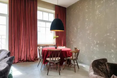 a dining room with a red table and chairs at Spacious, Very cosy, Stylish and Perfectly located in Vilnius