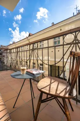 a table and a chair on a balcony with a building at Spacious, Very cosy, Stylish and Perfectly located in Vilnius