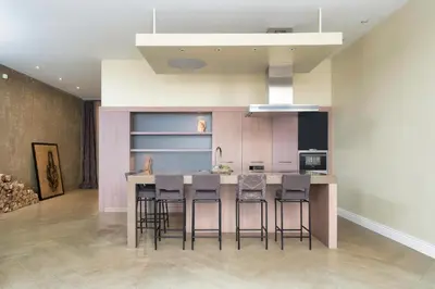a kitchen with a island with bar stools at Spacious, Very cosy, Stylish and Perfectly located in Vilnius