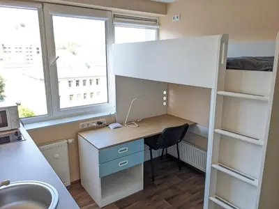 a room with a desk and a bunk bed at Mini Studio Apartment in Kaunas