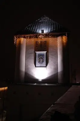 a building with a sign on it with lights at Komfortita in Utena