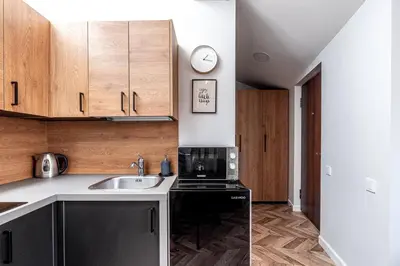 a kitchen with a sink and a stove at Oldtown Apartment studio #D in Vilnius