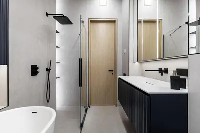 a bathroom with a toilet and a sink and a shower at Penthouse in Old Vilnius in Vilnius
