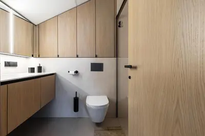 a bathroom with a toilet and a sink at Penthouse in Old Vilnius in Vilnius
