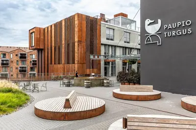 a courtyard with benches in front of a building at Penthouse in Old Vilnius in Vilnius