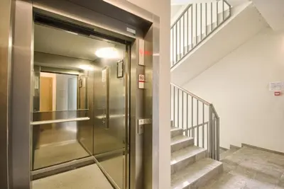 a elevator in a building with a staircase at Ballare Druskininkai in Druskininkai