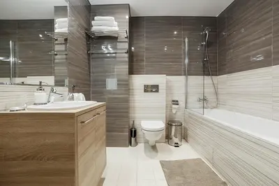 a bathroom with a tub and a toilet and a sink at Ballare Druskininkai in Druskininkai