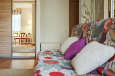 a couch with pillows on it in a living room at Ballare Druskininkai in Druskininkai