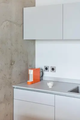 a white kitchen with white cabinets and a sink at Authentic 1 BD Apartment by Domvia in Kaunas