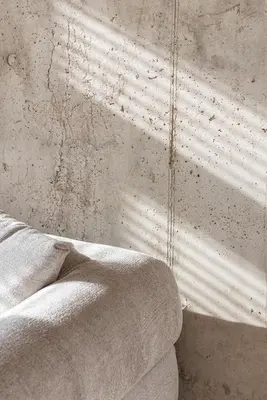 a bedroom with a bed and a concrete wall at Authentic 1 BD Apartment by Domvia in Kaunas