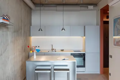 a kitchen with white cabinets and a kitchen island at Authentic 1 BD Apartment by Domvia in Kaunas