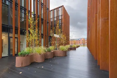 a walkway between two buildings with potted plants at Authentic 1 BD Apartment by Domvia in Kaunas