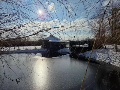 a view of a river with snow on the ground at Egliškių Oazė Sodyba su pirtimi kubilu- privatumas garantuotas in Vilnius