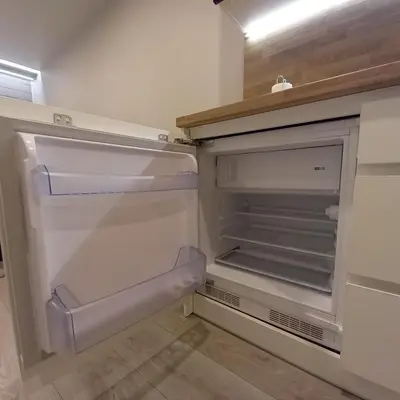 an empty refrigerator with its door open in a kitchen at Cozy small apartment #5A in Šiauliai