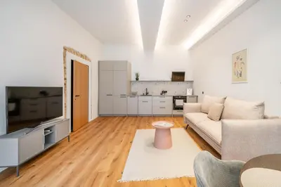 a living room with a couch and a tv at Newly Furnished Vilnius Town Hall Apartments by Reside Baltic in Vilnius