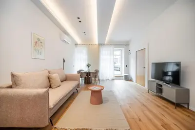a living room with a couch and a television at Newly Furnished Vilnius Town Hall Apartments by Reside Baltic in Vilnius