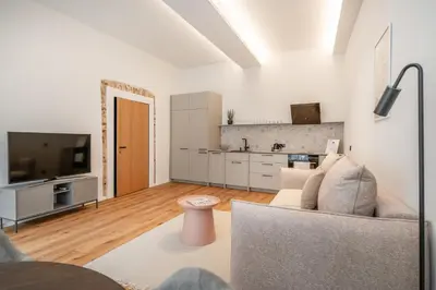 a living room with a couch and a tv at Newly Furnished Vilnius Town Hall Apartments by Reside Baltic in Vilnius