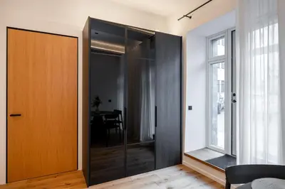 a sliding glass door in a room with a table at Newly Furnished Vilnius Town Hall Apartments by Reside Baltic in Vilnius