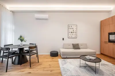 a living room with a table and a couch at Newly Furnished Vilnius Town Hall Apartments by Reside Baltic in Vilnius
