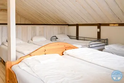 a group of four beds in a room at Uždubysio baidarės Sodyba už Dubysos in Ariogala