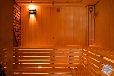 a bench in a room with a light on it at Uždubysio baidarės Sodyba už Dubysos in Ariogala