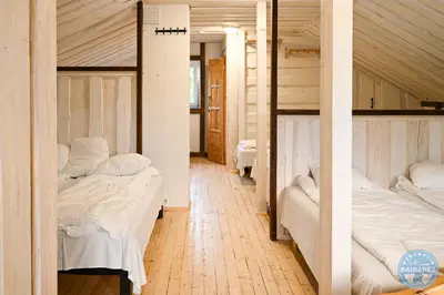 a room with two bunk beds and a hallway at Uždubysio baidarės Sodyba už Dubysos in Ariogala
