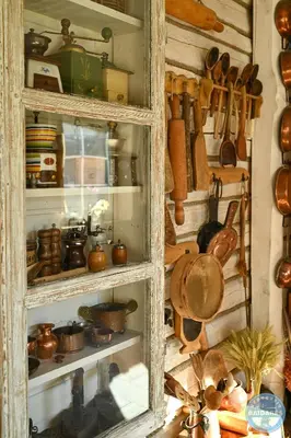 a cabinet filled with lots of pots and pans at Uždubysio baidarės Šimtametė Rezidencija in Ariogala