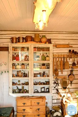 a cabinet filled with lots of pots and pans at Uždubysio baidarės Šimtametė Rezidencija in Ariogala