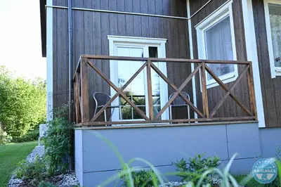 a screened in porch on the side of a house at Uždubysio baidarės Šimtametė Rezidencija in Ariogala