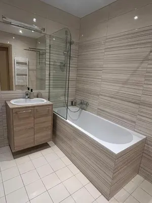 a bathroom with a tub and a sink at Vilniaus alėjos apartamentai in Druskininkai