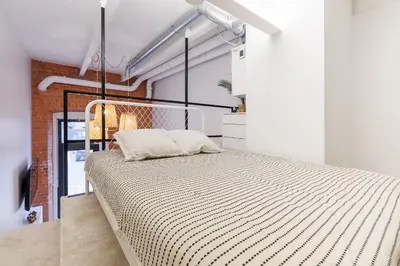 a bedroom with a large bed in a room at Pilot Loft in Kaunas