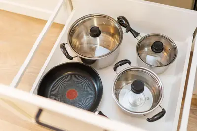four pots and pans sitting on a kitchen stove at Pilot Loft in Kaunas