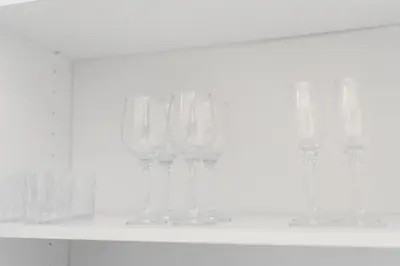 a row of wine glasses sitting on a shelf at Pilot Loft in Kaunas