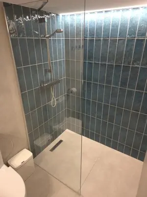 a bathroom with a glass shower with a toilet at Pilot Loft in Kaunas