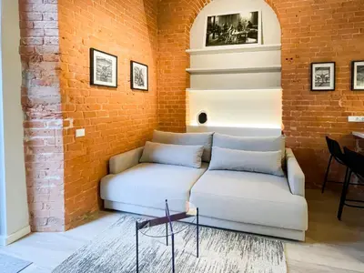 a living room with a couch and a brick wall at thePilots in Kaunas