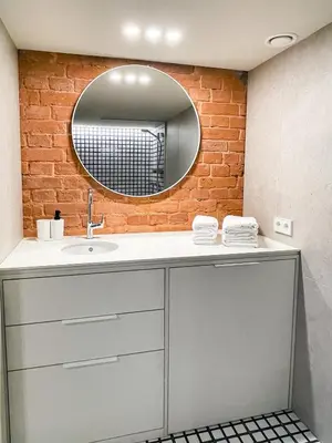 a bathroom with a sink and a brick wall at thePilots in Kaunas