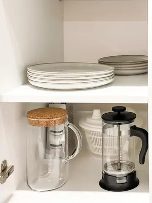 a kitchen shelf with plates and a blender at thePilots in Kaunas