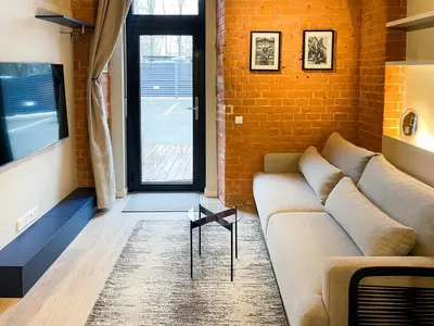 a living room with a couch and a brick wall at thePilots in Kaunas