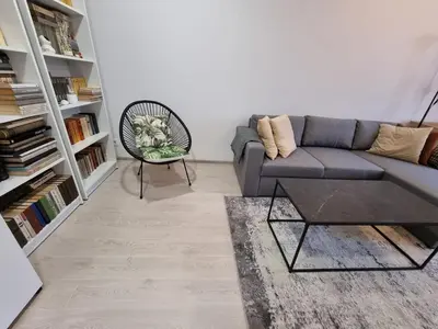 a living room with a couch and a chair at Refurbished central apartment in Vilnius