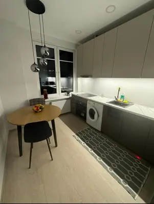 a kitchen with a table and a washing machine at Refurbished central apartment in Vilnius