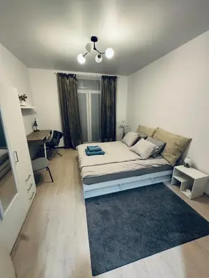 a bedroom with a bed and a desk in it at Refurbished central apartment in Vilnius