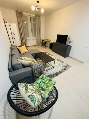 a living room with a couch and a table at Refurbished central apartment in Vilnius
