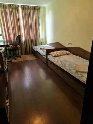 a bedroom with two beds and a desk and a chair at freeparking apartment in VNO