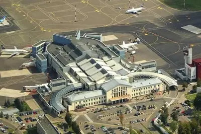 a large building with an airport with a plane at freeparking apartment in VNO