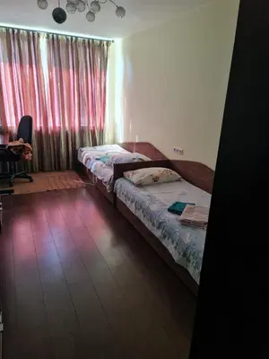 a bedroom with two beds and a window with curtains at freeparking apartment in VNO