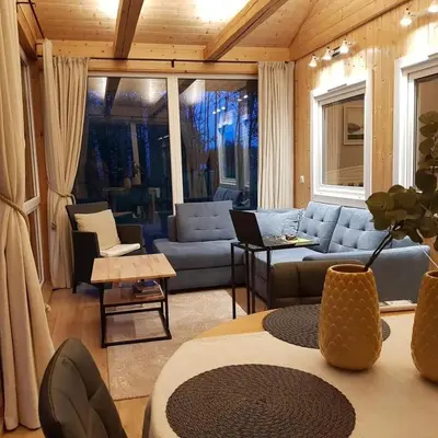 a living room with a couch and a table at Svedaso Lake House with Sauna in Svėdasai