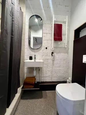 a white bathroom with a sink and a mirror at Apartamentai Kauno centre in Kaunas