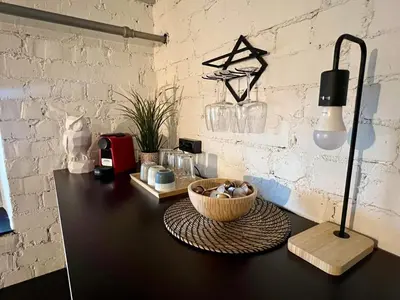 a desk with a basket on a table with a lamp at Apartamentai Kauno centre in Kaunas