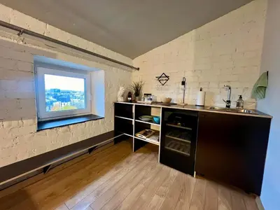 a kitchen with a sink and a window at Apartamentai Kauno centre in Kaunas