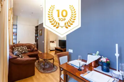 a living room with a couch and a table at Central apartments 1 x Free parking x Self Check in in Vilnius